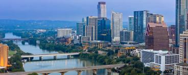 Colorado River and downtown city skyline of Austin at sunrise.
