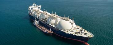 A small tanker on the roadstead bunkers a large LNG tanker