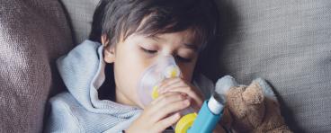 child using asthma inhaler