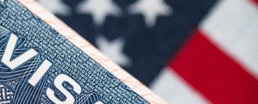 VISA to the USA and the flag of the United States of America. work and travel documents for visiting the USA. Visa for immigration.