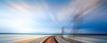 train tracks with motion of fast train visible at right