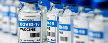 COVID-19 vaccine, vaccination bottles in a line.