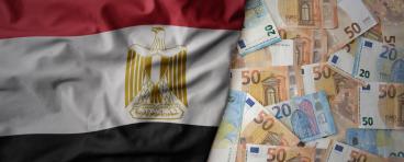Egyptian flag on the left on top of a layer of Euro notes