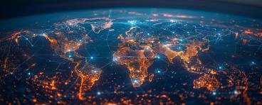 A world map with global network connections on the background of city lights at night.