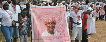 Supporters of President Umaro Sissoco Embalo show a red keffiyeh bearing his image during a political rally in Bissau