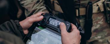 A group of Ukrainian military using tablet to operate the drone.