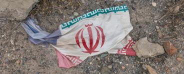 Iranian flag amidst debris