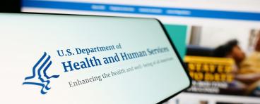 Mobile phone with logo of American Department of Health and Human Services (HHS)