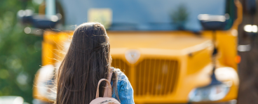 Student walking toward school bus