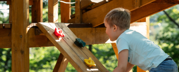 Child at play on colorful playground equipment